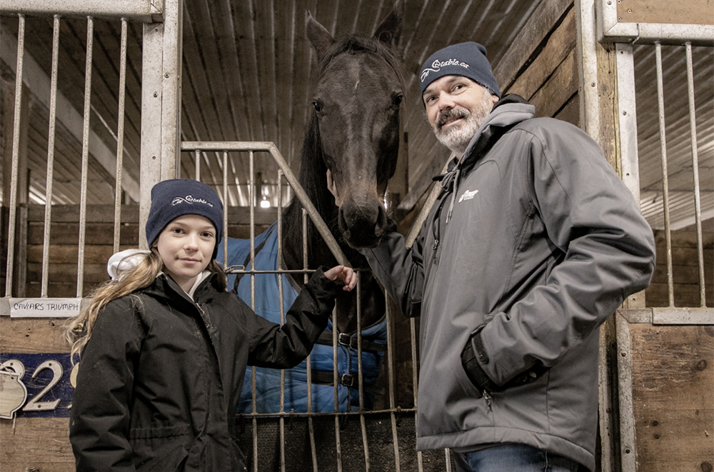 john and julia evans clients of TheStable.ca posing with standardbred racehorse caviars triumph